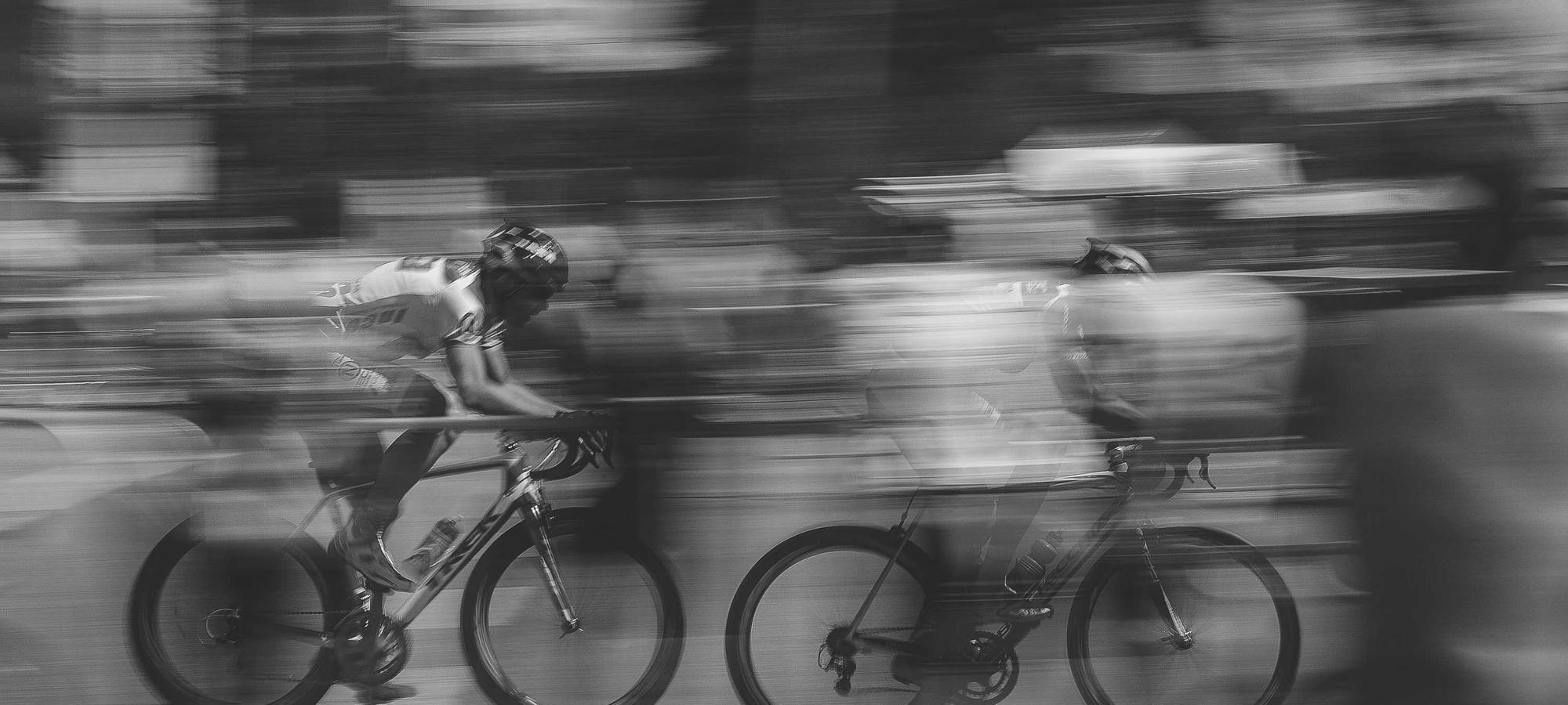 Cyclists in a tight pack, blurred by motion